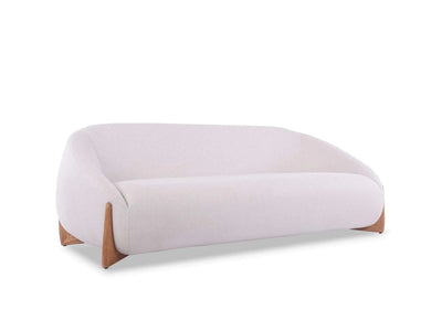 Dune 3 seater outdoor sofa with curved design, teak base, and light-colored Sunbrella fabric cushions for weather-resistant comfort
