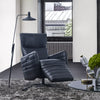 Evan Leather Armchair in a modern living room, black leather, reclined position, sleek design, swivel base.