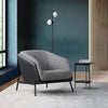 Fashion Leather Armchair in modern living room setting, featuring sleek design and checkered upholstery.