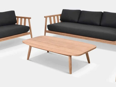 Finley Outdoor Teak Coffee Table with sleek design in patio setting.