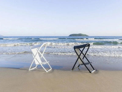 Halo Outdoor Lounge Chair on a beach with sleek design and all-weather functionality.