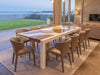 Imperial Outdoor Italian Lava Stone Dining Table handcrafted from basalt with hand-painted lava stone surface and powder-coated metal frame in a garden setting