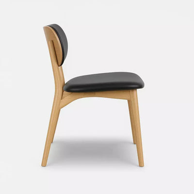 Jake Leather Dining Chair with black leather upholstery and natural timber frame, side view.