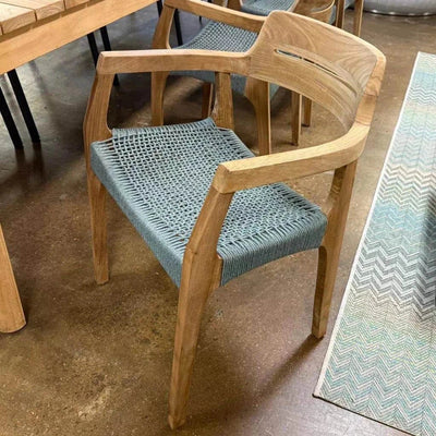 Jordan Outdoor Teak Dining Chair with curved backrest and handwoven seat in alfresco setting.