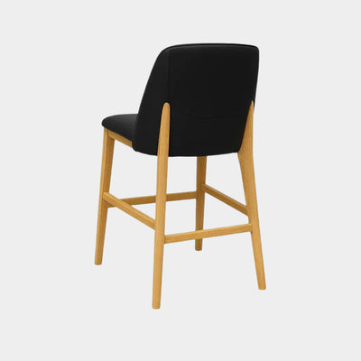 Kai Leather Bar Chair with black leather seat, curved backrest, and natural oak legs.