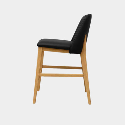 Sleek Kai Leather Bar Chair with black leather seat and natural oak legs.