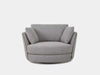 Kart Leather Armchair with curved design and plush cushions in fabric finish.