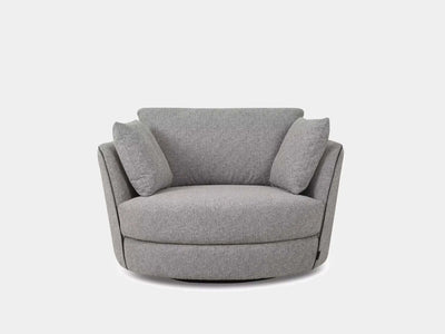 Kart Leather Armchair with curved design and plush cushions in fabric finish.