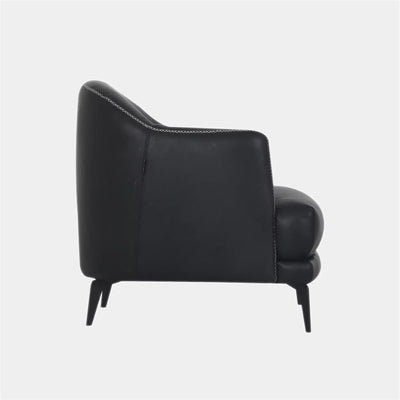 Kartik Leather Armchair side view with sleek black upholstery and metal legs.