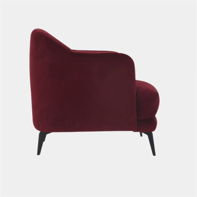 Kartik Leather Armchair in red with sleek metal legs and rounded back.