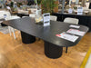 Lantone black dining table with rounded edges on Black November Sale displayed in furniture store