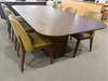 Lantone Dining Table in a modern setting, featuring a walnut finish and minimalist design with matching chairs.