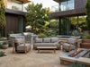 Lincoln outdoor sofa setting with teak frames and grey cushions in a contemporary patio setting