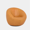 Lora Leather Armchair with sculptural rounded design in tan leather upholstery.