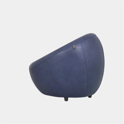 Lora Leather Armchair in blue with sculptural shell-like design on white background.