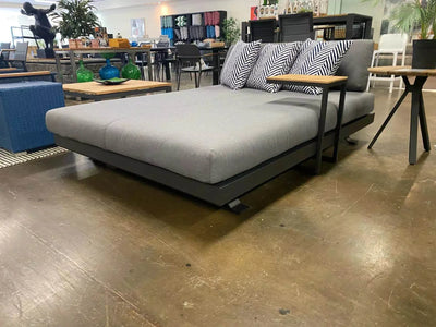 Luzon Daybed with sleek powder-coated aluminum frame and plush weather-resistant cushions in a modern outdoor setting.