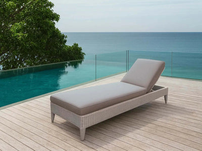 Malibu Sun Lounger in natural kubu with nature grey cushion by poolside with ocean view