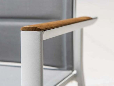 Marbella Outdoor Sling Dining Chair with teak trim armrest and aluminum frame.