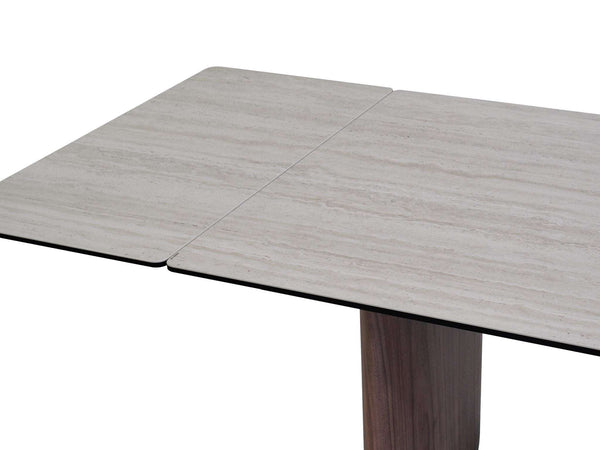 Mawson Twin Extendable Dining Table with tempered glass and ceramic travertine top, walnut veneer legs, and powder-coated steel frame, shown extended in modern dining room.