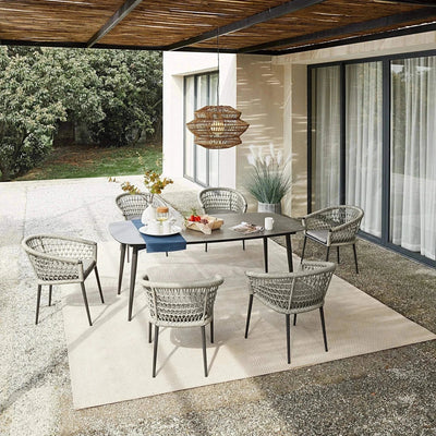 Muses Outdoor Rope Dining Chair in a modern outdoor setting with woven design and weather-resistant cushions.