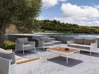 Nine Degrees Outdoor Lounge 1 Seater Sofa with synthetic teak armrests by a pool.