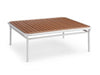 Nine Degrees Outdoor Coffee Table with a white aluminum frame and slatted brown synthetic teak tabletop