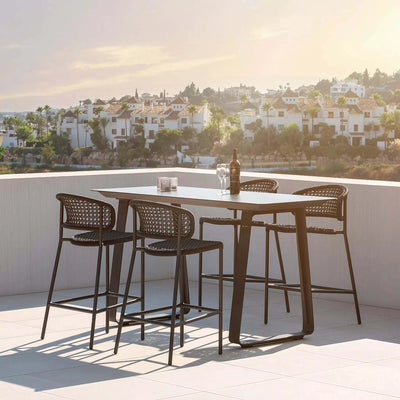 Butterfly Outdoor Bar Chair with elegant weaving on a rooftop patio.