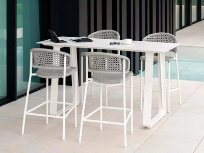 Butterfly Outdoor Bar Chair setup with elegant design and all-weather aluminum frame on a patio.