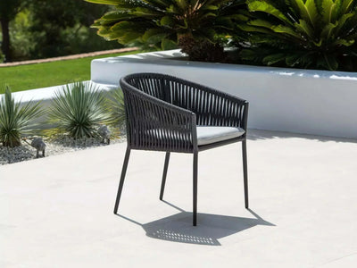 Jiselle Outdoor Rope Dining Chair with black rope and charcoal frame on patio.