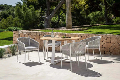 Jiselle Outdoor Rope Dining Chair with white frame and grey rope on patio.