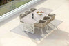 Jiselle Outdoor Rope Dining Chairs around a table on a patio, featuring elegant Italian rope weaving and durable aluminum frames.