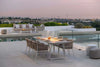 Jiselle Outdoor Rope Dining Chairs on patio by pool, showcasing elegant design and comfort.
