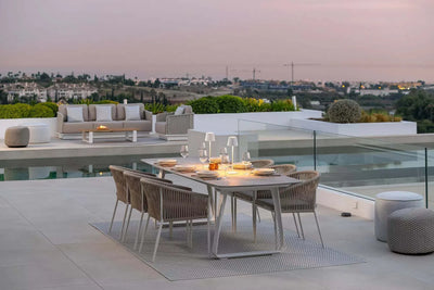 Jiselle Outdoor Rope Dining Chairs on patio by pool, showcasing elegant design and comfort.