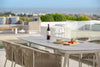 Jiselle Outdoor Rope Dining Chairs around a table on a modern patio.