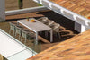 Jiselle Outdoor Rope Dining Chairs with Italian rope weaving and Sunbrella cushions around a modern table on a wooden deck.