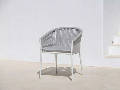 Jiselle Outdoor Rope Dining Chair with white frame and grey rope, featuring Sunbrella cushions, ideal for elegant outdoor dining.
