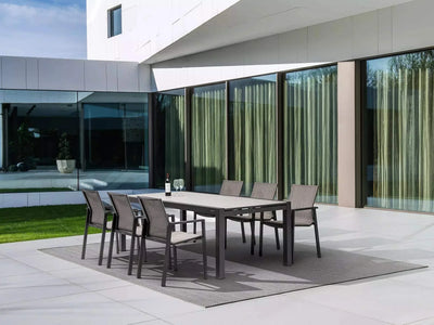 Livorno Outdoor Ceramic Extendable Dining Table with chairs on patio.