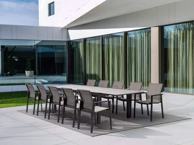 Livorno Outdoor Ceramic Extendable Dining Table set with chairs on modern patio.