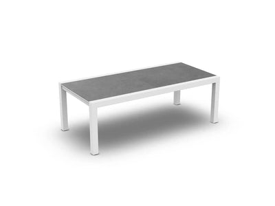 Livorno Outdoor Ceramic Extendable Dining Table with white frame and grey cement top, perfect for versatile outdoor dining.
