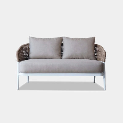 Como 2 Seater Outdoor Sofa with handwoven wicker and plush cushions on a powder-coated aluminum frame.