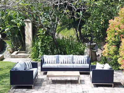 Avalon 6 Seater Outdoor Lounge Set in elegant garden setting with rattan weave and Sunbrella cushions.
