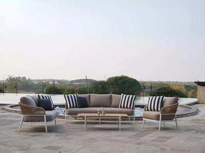 Como 6 Seater Outdoor Lounge Set beside a pool with stylish wicker design and soft cushions.