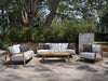 Corsica Outdoor Lounge - 1 Seater Outdoor Sofa in a garden setting with teak frame and plush cushions.