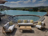 Corsica Outdoor Lounge 1 Seater Sofa by poolside, teak frame, white cushions, striped pillows.