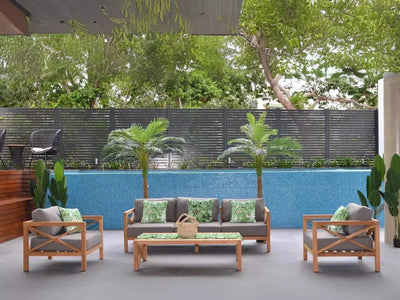 Harvard Outdoor Lounge 1 Seater Outdoor Sofa with recycled teak and plush Sunbrella cushions in a serene outdoor setting.
