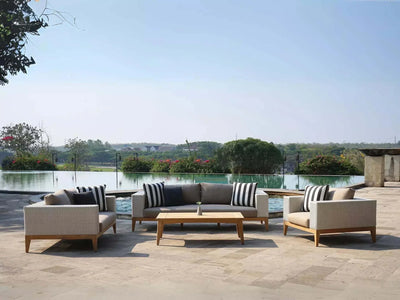 Manhattan Outdoor Lounge 3 Seater Sofa by poolside, teak and wicker design, elegant outdoor seating.