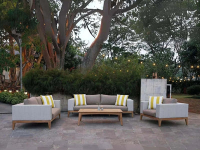 Manhattan Outdoor Lounge - 3 Seater Outdoor Sofa with teak wood base and handwoven wicker, featuring Sunbrella fabric cushions, in an elegant garden setting.