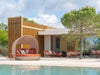 Palma rust outdoor daybed with matching outdoor furniture beside a pool