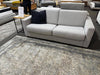 Grey Pasadena sofa bed with black cushion in furniture clearance sale showroom with price sign