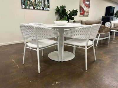 Pisa Outdoor Ceramic Round Dining Table with aluminum frame in a stylish setting.